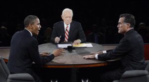 U.S. President Barack Obama makes a point while answering a question from moderator Bob Schieffer as Republican presidential nominee Mitt Romney listens during the final U.S. presidential debate in Boca Raton