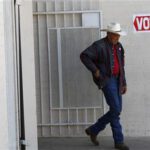 A voter exits a polling station after voting in Phoenix