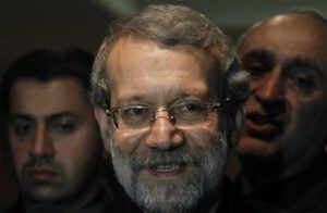 Iran's Parliament speaker Ali Larijani smiles after speaking to journalists at Beirut international airport