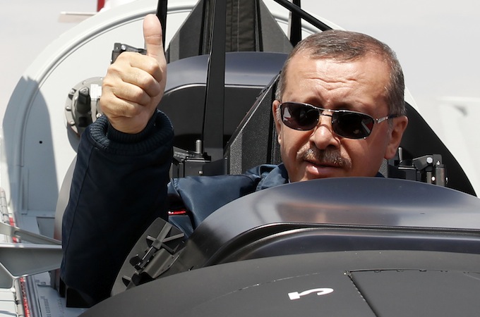 Turkish Prime Minister Tayyip Erdogan gives a thumbs-up sign from the cockpit of the Turkish Primary and Basic Trainer Aircraft "Hurkus" during a ceremony at the Turkish Aerospace Industries in Ankara