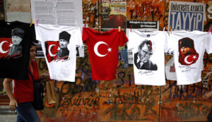 People walk by T-shirts with portraits of Mustafa Kemal Ataturk, founder of modern Turkey, near Taksim Square in Istanbul