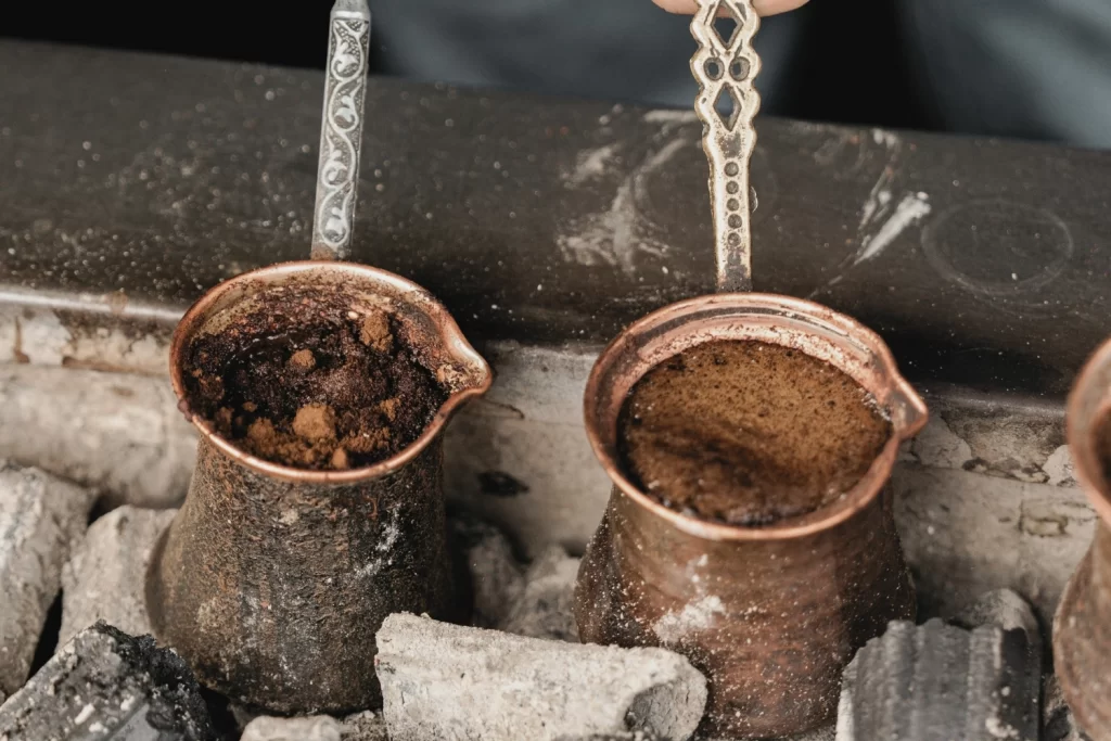 Traditional Turkish coffee brewing in a copper pot, fortune-telling